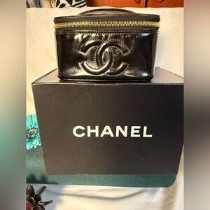 CHANEL Glossy Black Cosmetic Bag with Gold Accents